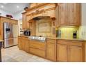 Gourmet kitchen offering stainless steel appliances, light wood cabinetry, and a granite countertop with tile backsplash at 32510 Wolf Branch Ln, Sorrento, FL 32776
