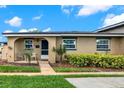Charming single-story home with a cozy front porch and lush green landscaping at 516 Polaris Loop # 110, Casselberry, FL 32707
