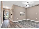Living room with fresh paint, baseboards, grey wood-look floors and lots of natural light at 516 Polaris Loop # 110, Casselberry, FL 32707