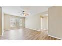 Spacious living room featuring wood-look floors and a large window for ample natural light at 5512 Metrowest Blvd # 203, Orlando, FL 32811