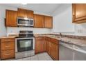 Well-lit kitchen showcasing stainless steel appliances, ample counter space, and modern cabinetry at 66 Silver Falls Cir, Kissimmee, FL 34743