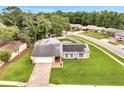 Aerial view of a single-story home with a solar panels, a pool, an attached garage, and a manicured front lawn at 819 Haulover Dr, Altamonte Springs, FL 32714
