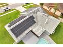 Aerial view showcasing solar panels and roof features above the pool and covered lanai at 819 Haulover Dr, Altamonte Springs, FL 32714