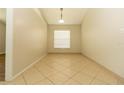 Bright dining area with tile flooring, a window, and ample space for entertaining guests at 11547 Grazeley Ct, Orlando, FL 32837