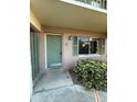 Inviting entryway with a charming green door, matching shutters, and a well-maintained garden at 131 Water Front Way # 110, Altamonte Springs, FL 32701