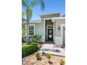 Inviting front entrance with a 'Welcome' sign, lush landscaping, and a well-maintained walkway at 14137 Queenside St, Orlando, FL 32824