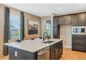 Well-appointed kitchen featuring an island, stainless steel appliances, and plenty of cabinet space at 15201 Summer Harvest St, Winter Garden, FL 34787
