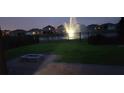 Nighttime view of a fenced in backyard with a water feature at 16124 Azure Key St, Winter Garden, FL 34787
