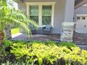 Inviting front porch with stone pillars and comfortable seating area at 16124 Azure Key St, Winter Garden, FL 34787