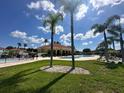 Enjoy the community pool on a sunny day, surrounded by palm trees and lush landscaping at 1840 Coriander Dr, Kissimmee, FL 34759