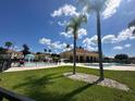 Community pool has lounge chairs and umbrellas, ideal for relaxing in a resort setting at 1840 Coriander Dr, Kissimmee, FL 34759