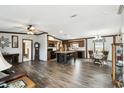 Bright open concept features wood trim, plank flooring, and a center island at 18906 Merrich Rd, Orlando, FL 32820
