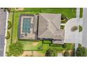 Aerial view of a home showcasing a screened-in pool and lush backyard at 2365 Sterling Creek Pkwy, Oviedo, FL 32766