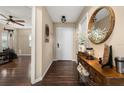 Welcoming foyer with hardwood floors, decorative table, and view into adjacent living area at 241 Lake Thomas Dr, Winter Haven, FL 33880