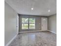 Bright living room with neutral paint, recessed lighting, and tile floors at 3220 Mahalia Pl, Orlando, FL 32805