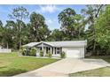 Charming single story home featuring a manicured lawn and lovely front porch seating area at 368 E Chelsea St, Deland, FL 32724