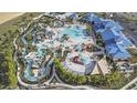 Aerial view of the resort-style community pool and water park featuring slides and relaxation areas at 3806 Lana Ave, Davenport, FL 33897