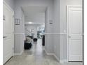 Clean and bright hallway with white trim, tile flooring, and views to the outdoor pool area at 3806 Lana Ave, Davenport, FL 33897