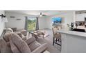 Open-concept living room showcasing comfortable seating and access to the backyard at 4743 Sw 114Th Pl, Ocala, FL 34476
