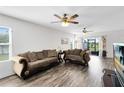 Spacious living room with hardwood floors and plush seating arrangement at 4801 Apple Blossom Ln, St Cloud, FL 34771