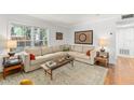 Comfortable living room with neutral tones, a large window, and stylish decor at 4820 S Conway Rd # 131, Orlando, FL 32812