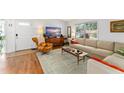 Bright living room with a large window, cozy seating, and stylish decor elements at 4820 S Conway Rd # 131, Orlando, FL 32812