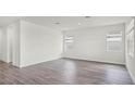 Bright, airy living room featuring wood-look floors and large windows offering plenty of natural light at 5227 Ligonberry St, Lakeland, FL 33811