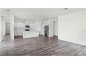 Open floor plan showcasing living room blending into modern white kitchen with stainless steel appliances at 5227 Ligonberry St, Lakeland, FL 33811