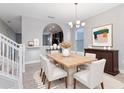 Bright dining room featuring neutral walls, large windows, and modern furnishings at 5270 Wildwood Way, Davenport, FL 33837