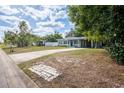 Inviting single-story home with a long driveway, charming curb appeal, and a well-kept lawn at 6124 Bear Lake Ter, Apopka, FL 32703