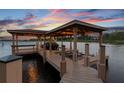 Well-maintained boat dock featuring sturdy construction, ample covered space, and easy access to the serene lake at 616 Grand Cypress Pt, Sanford, FL 32771