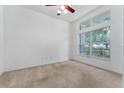 Bright, carpeted bedroom with a large window offering lots of natural light at 6550 Crestmont Glen Ln, Windermere, FL 34786