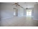 Bright, open-concept living room with tile flooring and sliding glass doors leading to the lanai at 7700 Greytwig Ln, Orlando, FL 32818