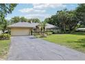 Single-Gathering home with an attached two-car garage and manicured front yard at 7779 Lake Andrea Cir, Mount Dora, FL 32757