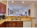 Kitchen view looking out to dining and living spaces, granite counters, and stainless sink at 8000 Tuscany Way # 4408, Davenport, FL 33896