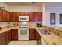 Bright kitchen featuring granite countertops, stainless steel sink, and matching appliances at 8000 Tuscany Way # 4408, Davenport, FL 33896