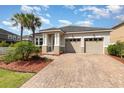 Charming single-story home boasting a two-car garage and a brick paver driveway at 8058 Corkfield Ave, Orlando, FL 32832