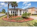 Well-maintained home with manicured front yard, mulch beds, and lovely curb appeal at 8058 Corkfield Ave, Orlando, FL 32832