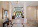 Elegant living room features plush seating, coffered ceilings, recessed lighting, and pool views at 9138 Pinnacle Cir, Windermere, FL 34786