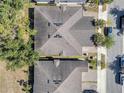 Overhead view of residential homes with dark gray roofs, showing landscaping, driveways and street parking available to residents at 1840 Shumard Ave, St Cloud, FL 34771