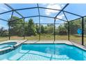 Private screened-in pool area with clear blue water and ample space for relaxation and recreation at 2009 Tropical Palms Cir, Kissimmee, FL 34747