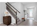 Welcoming foyer with tiled floor and staircase adjacent to front door, leading to upper level at 2751 Matera Dr, St Cloud, FL 34771