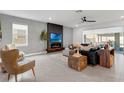 Comfortable living room featuring a modern fireplace, decorative wall, and stylish furniture at 2751 Matera Dr, St Cloud, FL 34771