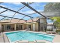 Relaxing screened-in pool area with ample seating and a well-maintained pool at 3016 Samosa Hill Cir, Clermont, FL 34714