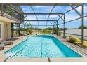 Relaxing screened-in pool and spa with a tranquil backyard view at 3016 Samosa Hill Cir, Clermont, FL 34714