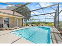 Enjoy this screened-in pool with lounge chairs for ultimate relaxation at 3016 Samosa Hill Cir, Clermont, FL 34714