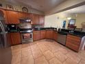 Well-lit kitchen features stainless steel appliances, granite countertops, and tile backsplash at 3327 Toasy Dr, Orlando, FL 32806