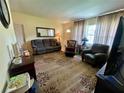Inviting living room features a comfortable couch, complementary armchair and a decorative area rug at 3327 Toasy Dr, Orlando, FL 32806