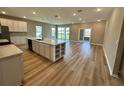 Open-concept kitchen features an island, white cabinetry, modern appliances, and plenty of countertop space at 4009 Maggie Loop, Lakeland, FL 33813