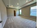 Spacious primary bedroom boasts plush carpeting, recessed lighting and plenty of natural light at 4009 Maggie Loop, Lakeland, FL 33813